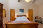 The bedroom is super spacious - now with a new bed. The en suite bathroom is through the door to the right of this photo.