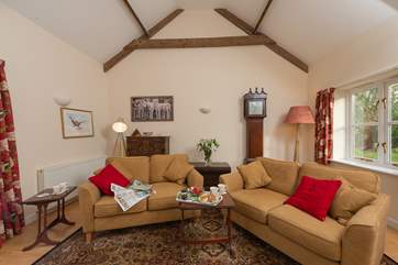 The sitting-room has plenty of space and some lovely pieces of furniture to add character to this welcoming barn conversion.