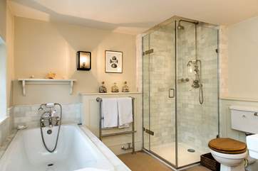 One of 2 bathrooms on the first floor - with a separate bath, shower cubicle and twin wash-basins.