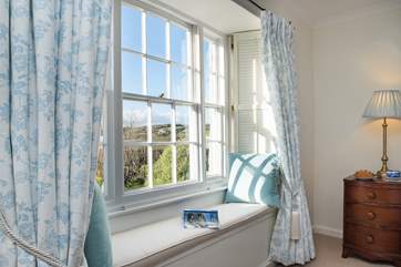 The window seat provides a lovely spot to unwind with a good book.