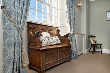 The light floods in through the large windows at the front of the house.