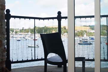 Sit on the balcony and watch the boats go by.