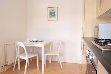 There is a little breakfast table in the kitchen.