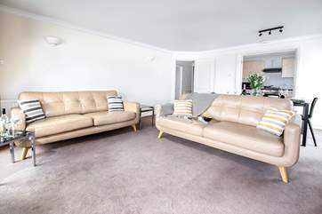 The open plan living space opens to the kitchen - plenty of space for everyone.