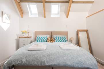 The bedroom is lovely and light with calming tones.