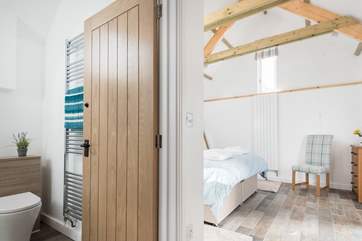 The en suite shower-room is next to the bedroom up three steps from the living space.