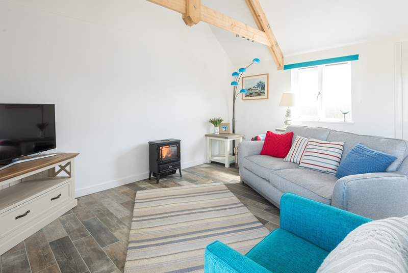 The open plan living space has a warming electric fire.