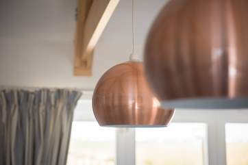 Modern lights hang from the traditional oak beams.