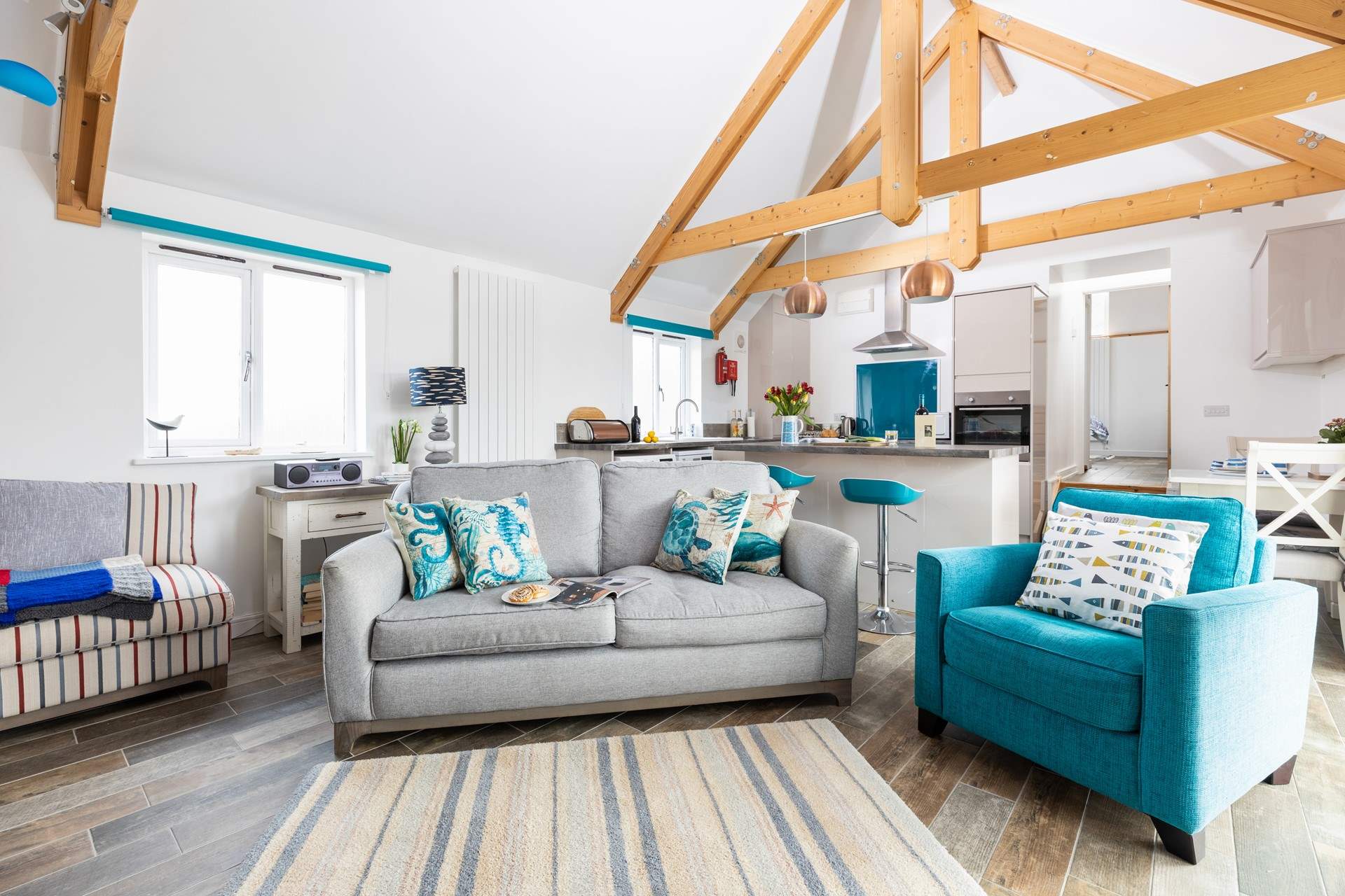 The delightful open plan living space has a warming electric fire.