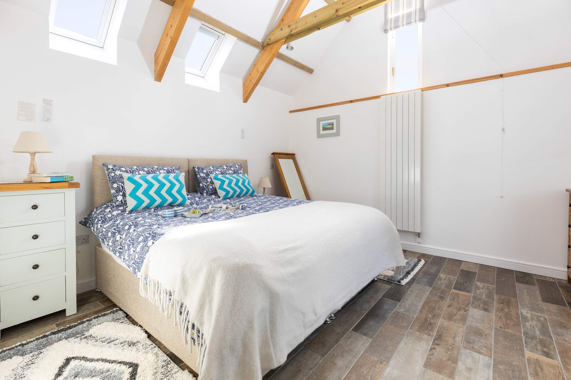 The bedroom is lovely and light with calming tones.