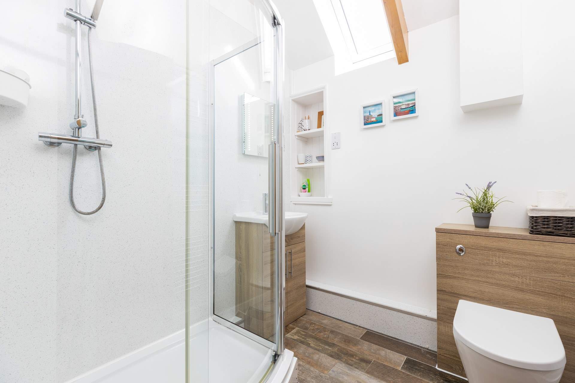 The en suite shower-room is next to the bedroom, three steps up from the living space.