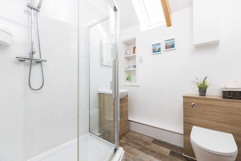 The en suite shower-room is next to the bedroom up three steps from the living space.