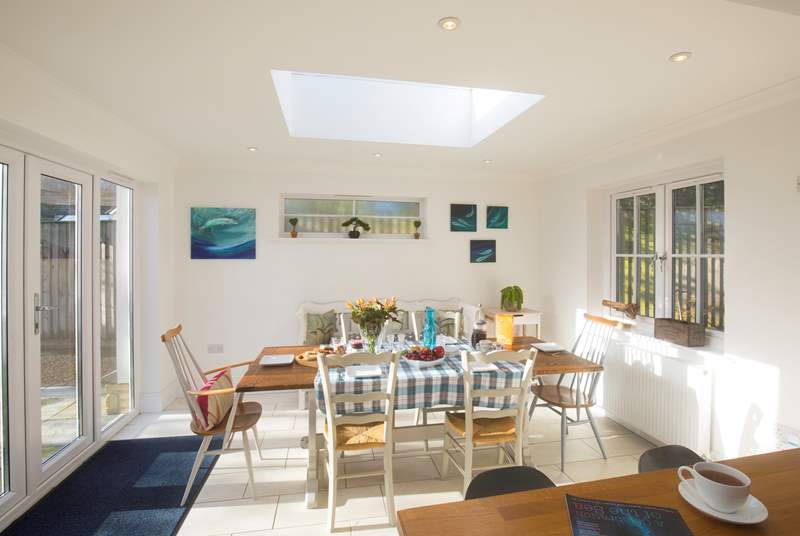 The stunning dining-area has a large table seating eight and patio doors out to the garden to open up on those sunny days.