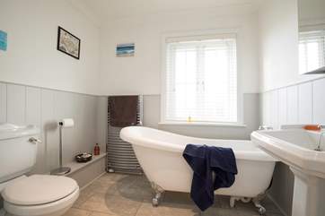 Run the hot water, pour in bubbles and fill the gorgeous roll-top bath for a relaxing soak.