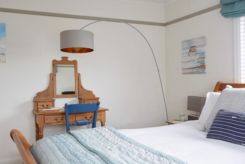 The large main bedroom has a lovely dressing-table with super-king bed.