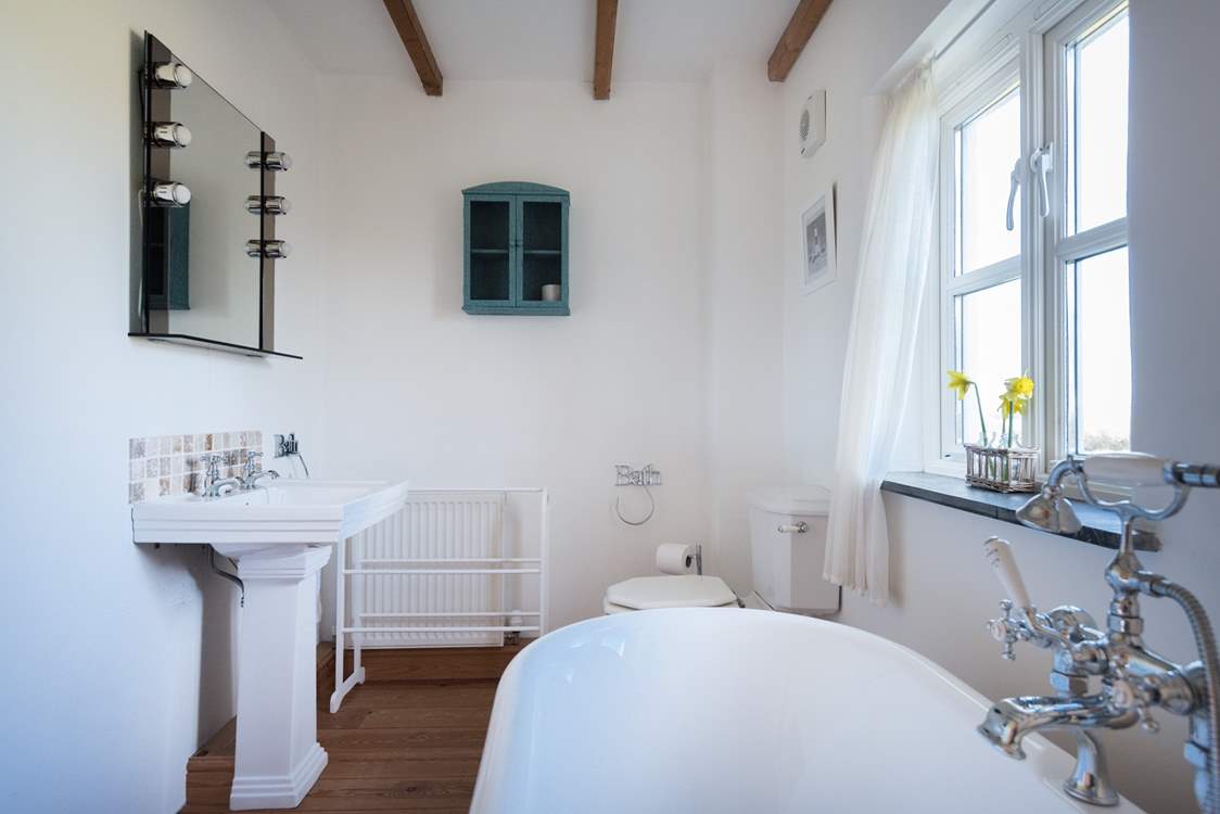 The en suite bathroom with roll-top bath.