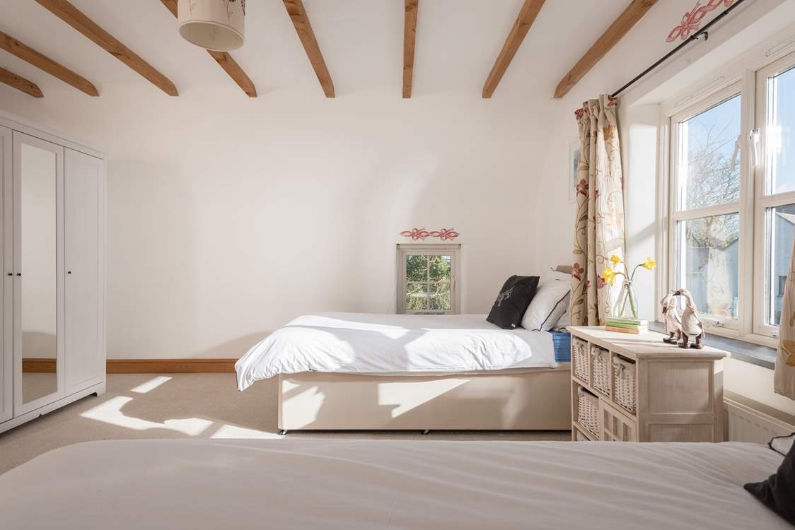 The twin bedroom is flooded with light.