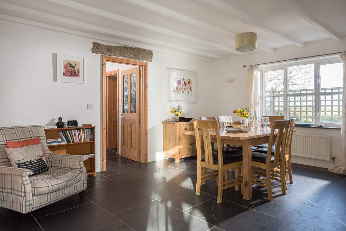 The dining-room with a door that leads to the private garden, shower-room and utility-room.