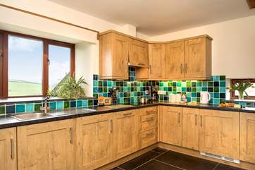 The well-equipped kitchen fully embraces the view.