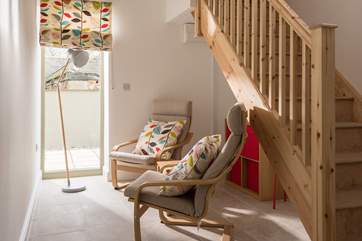 The area at the bottom of the stairs is a quiet space or a play area for the younger ones.