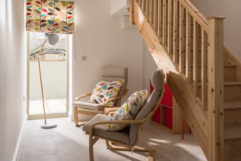 The area at the bottom of the stairs is a quiet space or a play area for the younger ones.