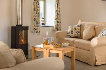 The open plan living space has areas for relaxing, dining and cooking.