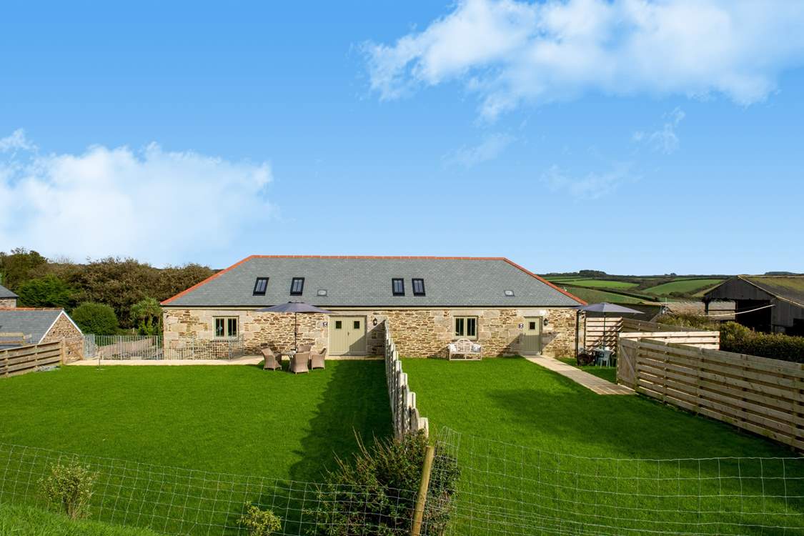 The Bull Pen is the barn on the right of the picture and has parking alongside the garden and  views over the farmyard and fields beyond.