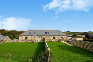 The Bull Pen is the barn on the right of the picture with parking alongside the garden with views over the farmyard and fields beyond.