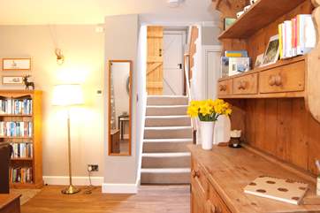 Stairs lead from the sitting-room to the kitchen/dining-room and the bathroom.