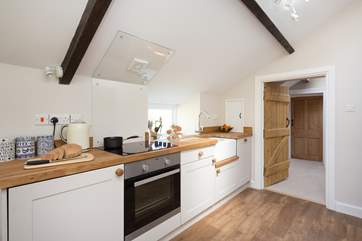 The kitchen and bathroom are off a half-landing between the living-room and the bedrooms