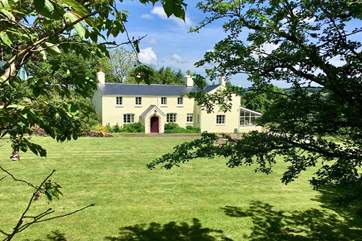 Stockham Farm is a stunning traditional Exmoor farmhouse. Guests have the Victorian annexe - to the left of, and above the porch - all to themselves as well as a side garden and the lawns in front of
