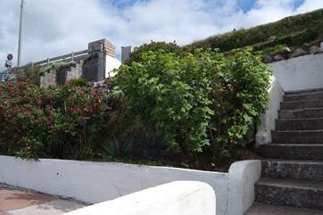 Steps lead down from the parking-area to the bungalow.
