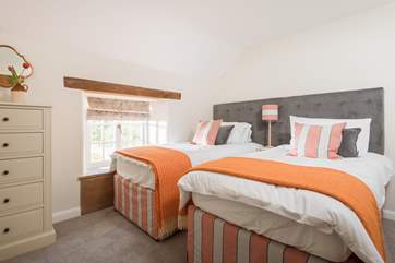 The twin bedroom looks out over the garden.