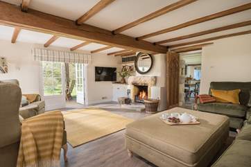 Relax in front of the fire in this luxurious sitting-room.