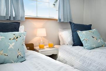 Lovely crisp white linen and plump cushions adorn the beds.