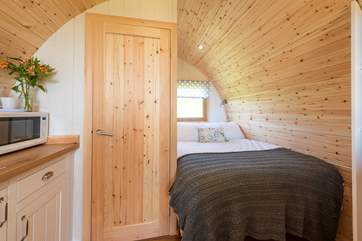 The double bed is tucked in to the rear of the pod.