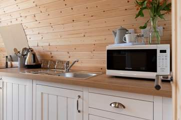 The well-equipped kitchen area, complete with kettle (for that all-important morning cuppa!), electric cooker, microwave, toaster and fridge.