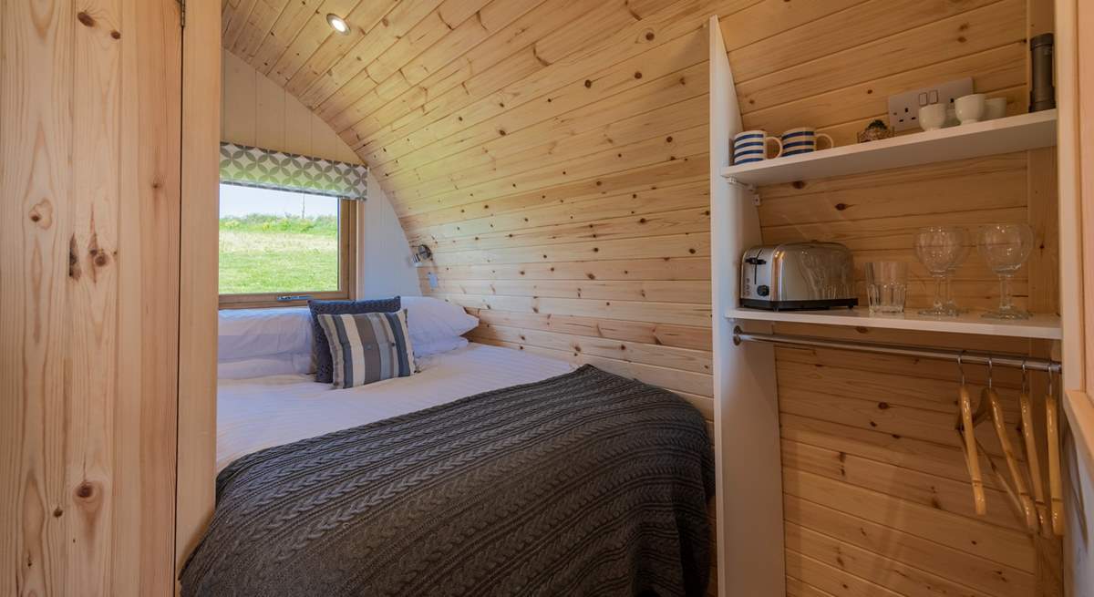 The double bed is tucked into the rear of the pod.