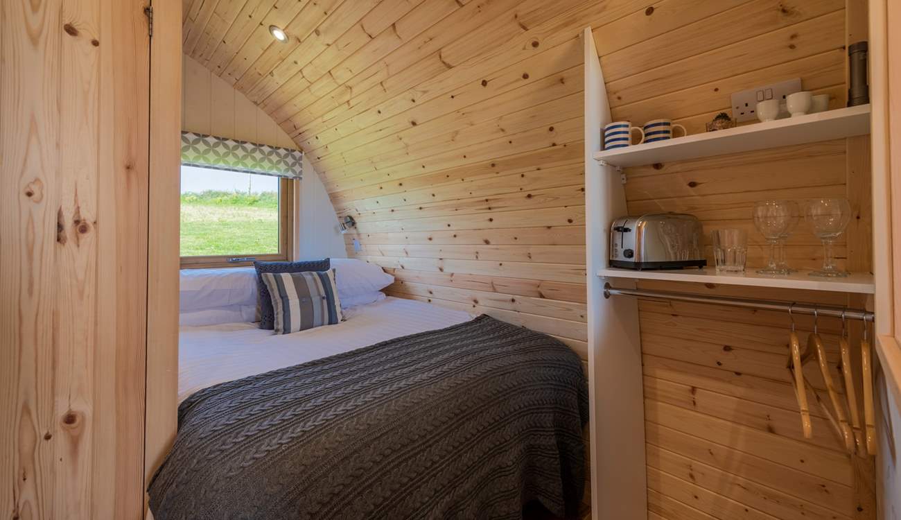 The double bed is tucked into the rear of the pod.
