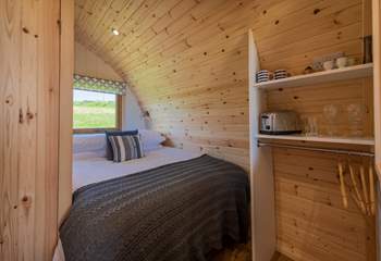 The double bed is tucked into the rear of the pod.