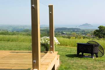 The deck is sheltered by glazed panels on two sides.