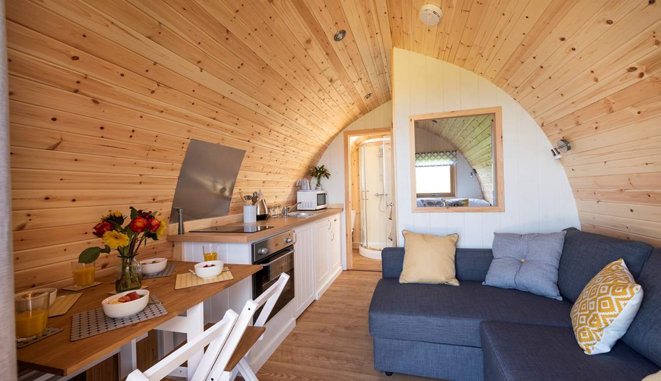 Deceptively spacious inside with a double bed at the rear, the en suite shower-room, kitchen-area, dining-area and sitting-area (where the sofa easily converts into a huge double bed).