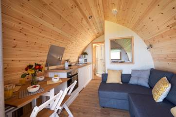 Deceptively spacious inside with a double bed at the rear, the en suite shower-room, kitchen-area, dining-area and sitting-area (where the sofa easily converts into a huge double bed).