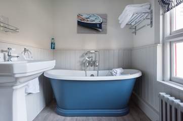The family bathroom has a pretty free-standing, roll-top bath.