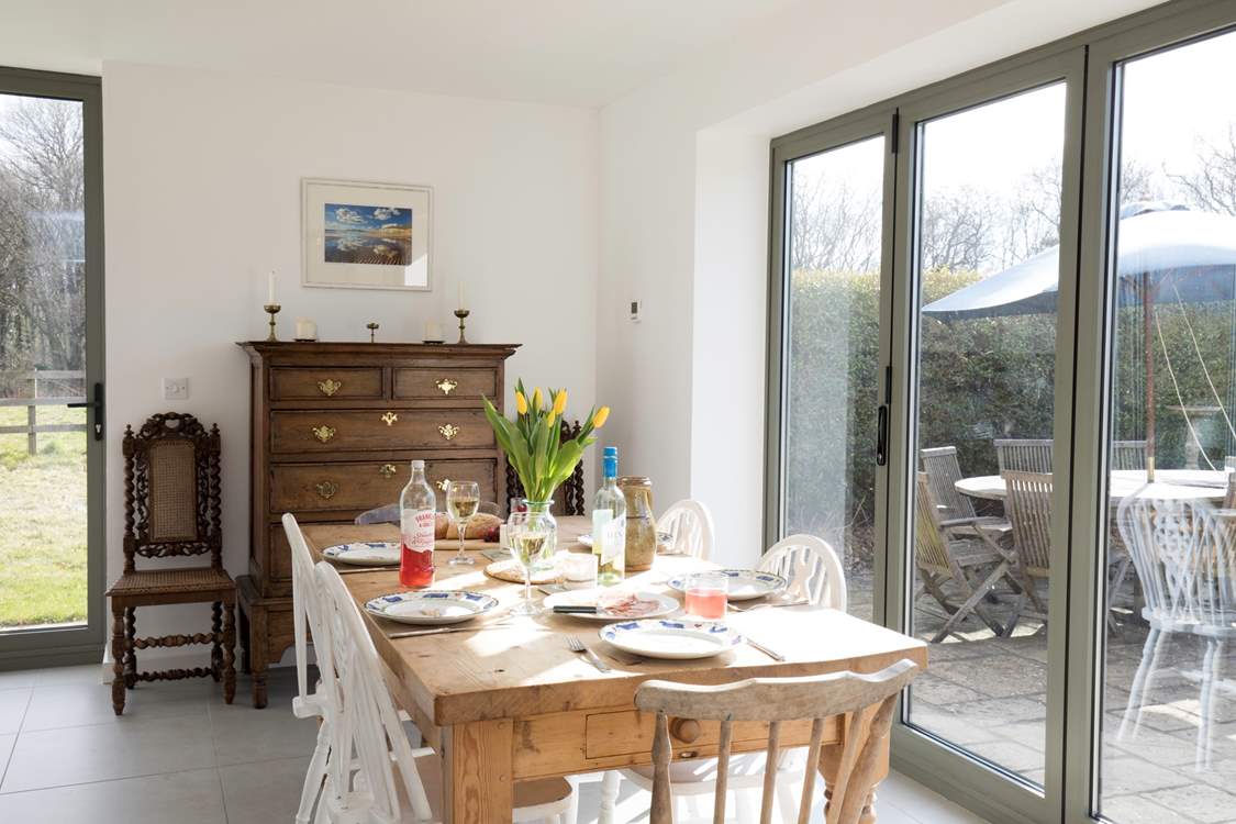 The stunning dining-area has a large table seating six with doors, out to the patio and garden, which you can open up on those sunny days.