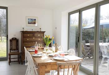 The stunning dining-area has a large table seating six with doors, out to the patio and garden, which you can open up on those sunny days.