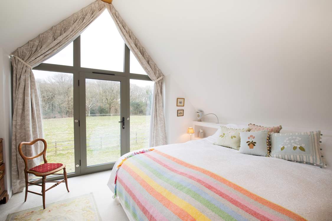 The stunning main bedroom with super-king size bed accessed via its own private staircase.