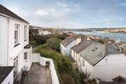 3 Thetis Place is the end of a small terrace of three cottages accessed through a private gateway onto their shared terrace, the house is now also painted blue.