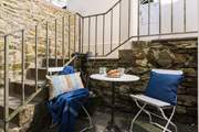 The little courtyard outside the kitchen at the rear of the cottage is perfect for sunny summer evening meals.