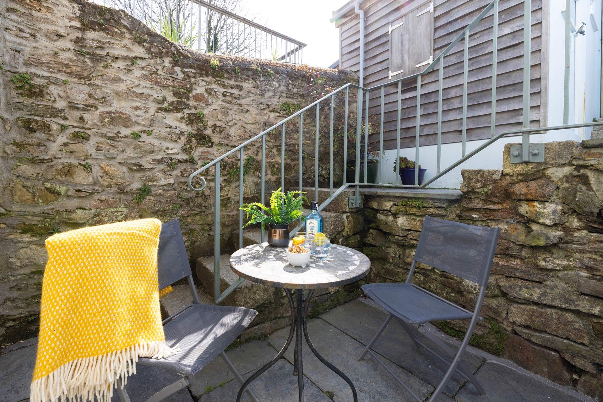 The cute courtyard at the back of the cottage catches the afternoon sun. 